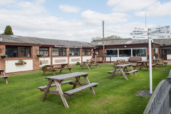 Picnic benches and outdoor space by the restaurant at Sherburn Aero Club
