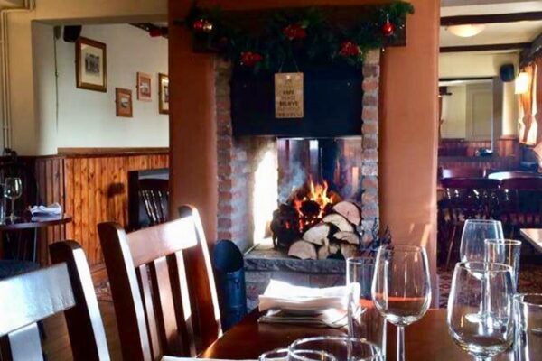 Table set for dinner in front of the fireplace at The Drovers Arms in Skipwith Table set for dinner in front of the fireplace at The Drovers Arms in Skipwith